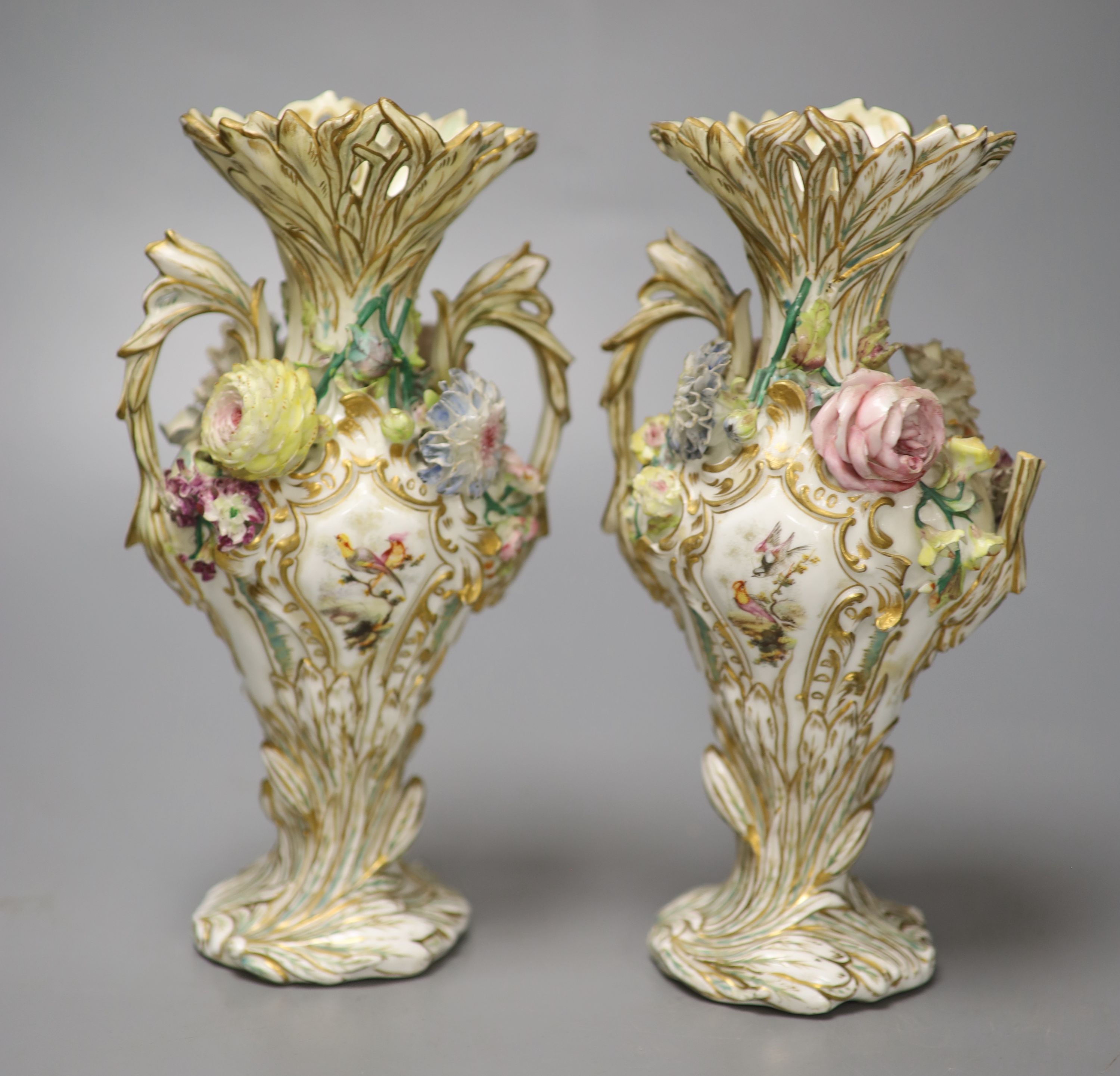 An English porcelain two handled green ground vase and a pair of floral encrusted vases, 20cm